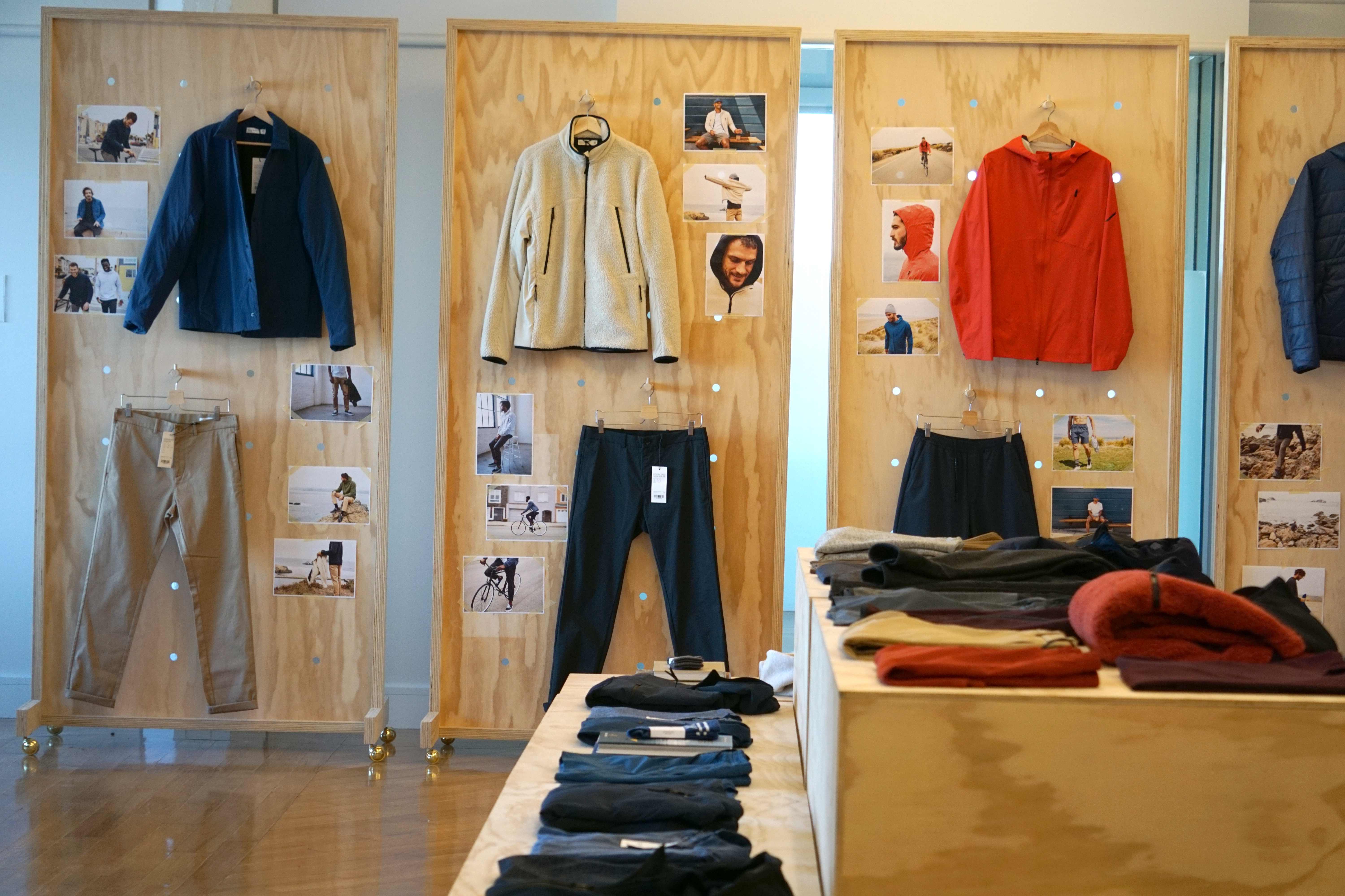Clothing retail display with garments on wooden panels